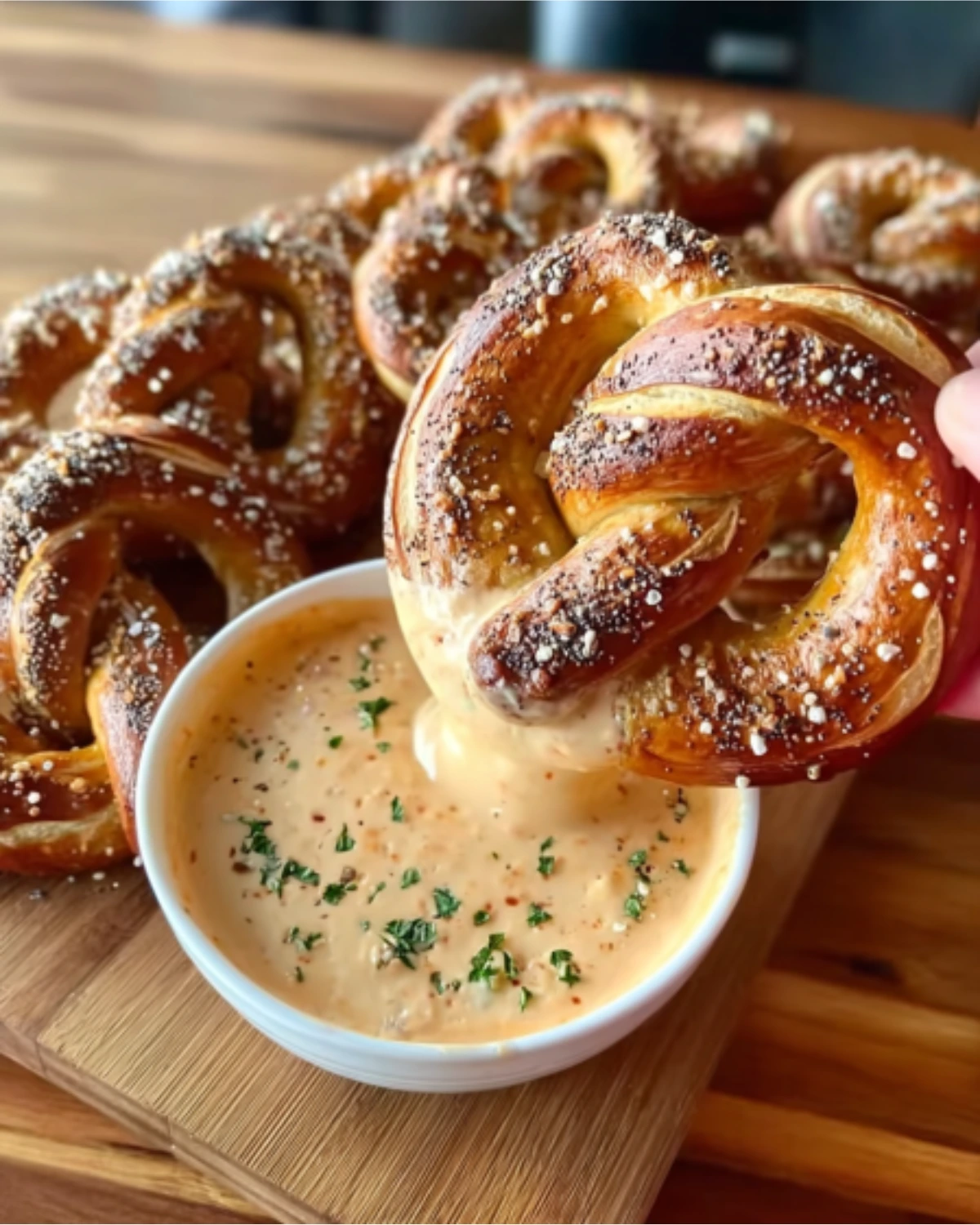 Homemade Pretzel Cheese Dip with soft pretzels sprinkled with salt and dipped into creamy cheddar sauce