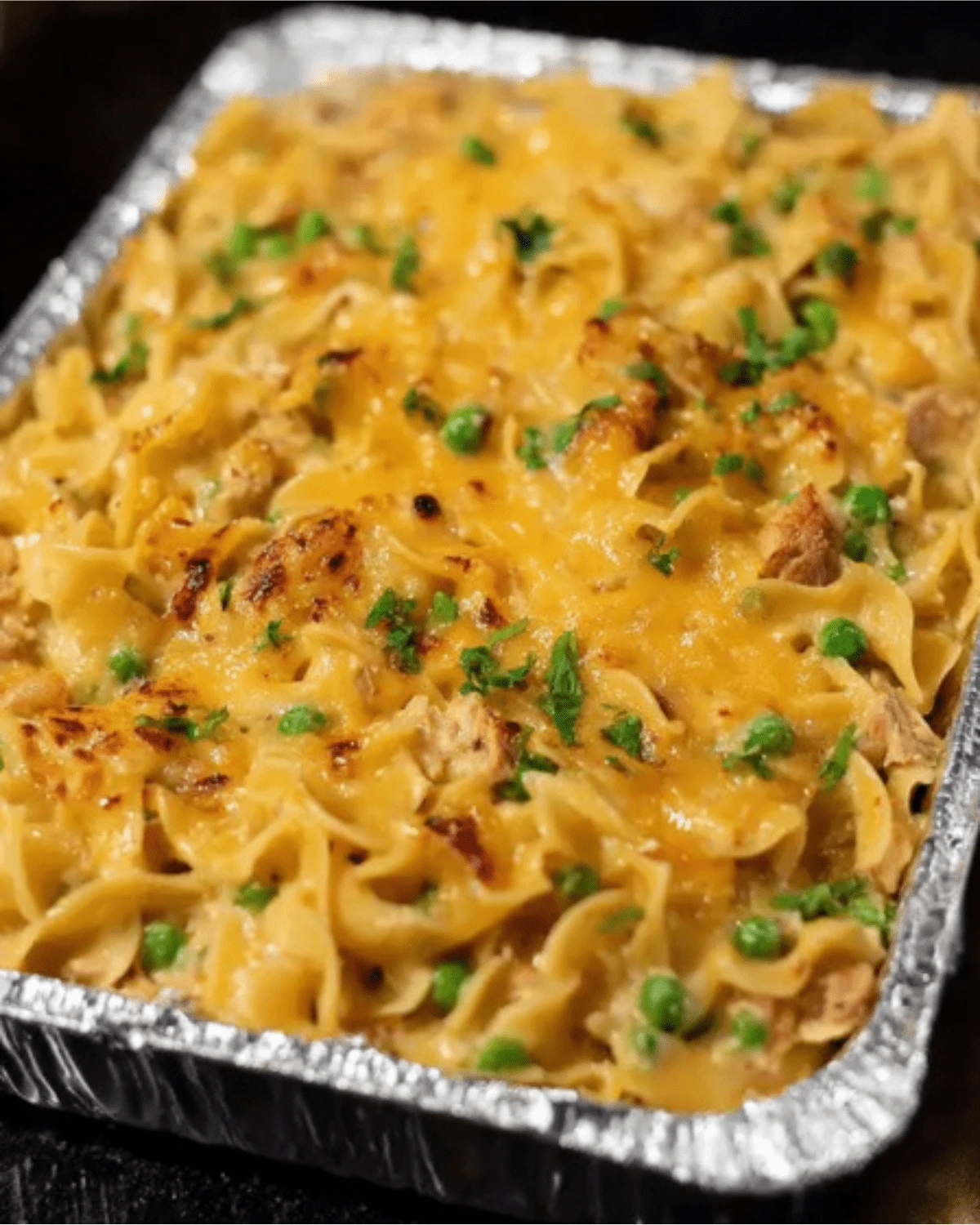 4-ingredient-tuna-casserole-cheesy-bake Cheesy baked 4 ingredient tuna casserole with green peas in a foil tray
