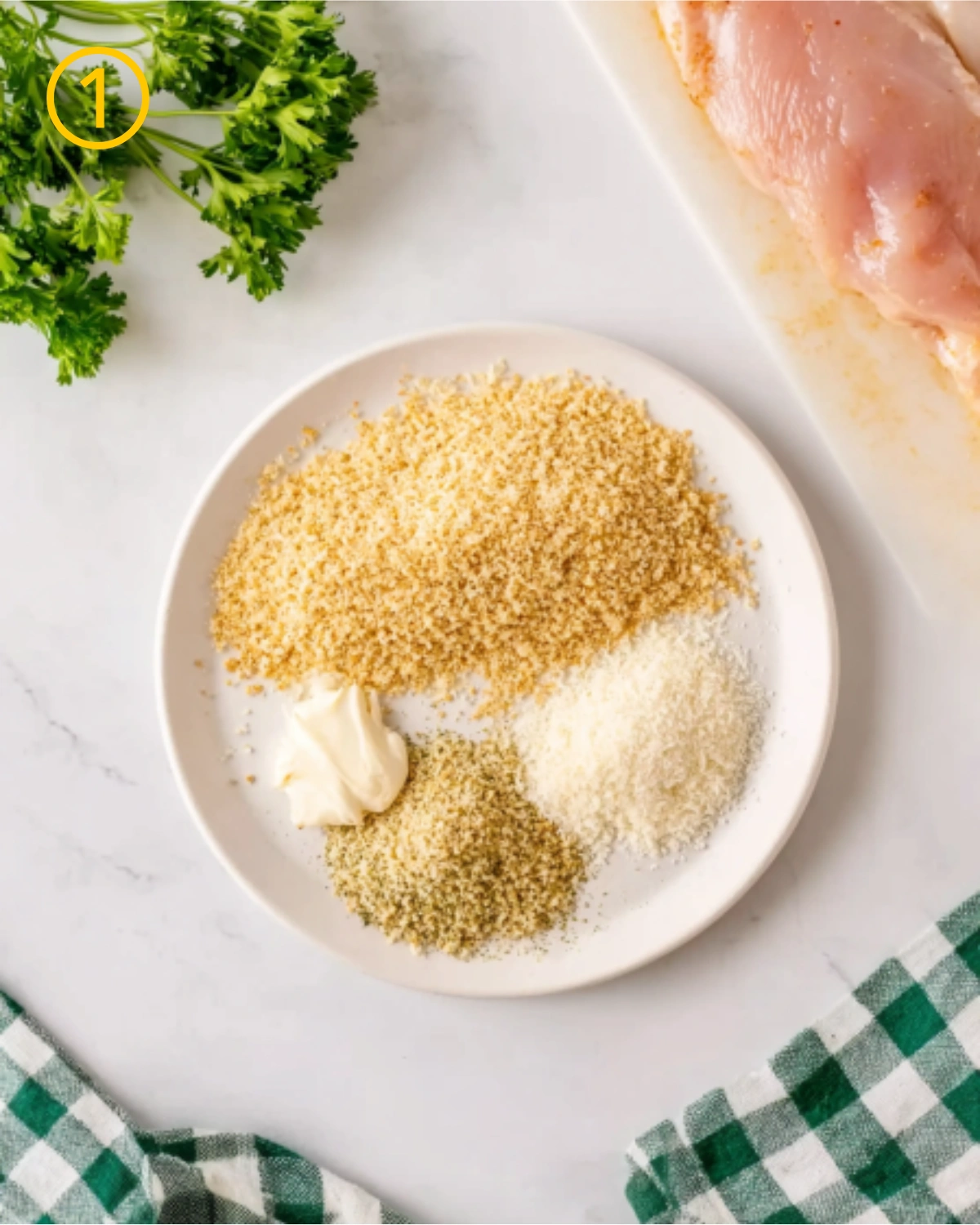 Step one ingredients for Air Fryer Parmesan Crusted Chicken including breadcrumbs, parmesan cheese, herbs, and mayonnaise on a plate