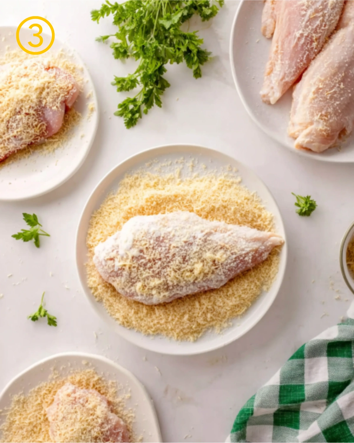 Step three of Air Fryer Parmesan Crusted Chicken showing raw chicken breasts coated in parmesan and breadcrumbs