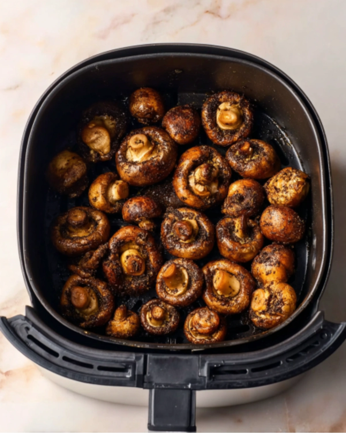 crispy-air-fryer-mushrooms-cooked Crispy and golden Air Fryer Mushrooms freshly cooked in the air fryer basket