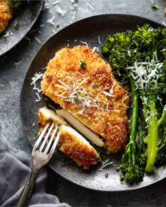 Parmesan Crusted Chicken Recipe served with broccolini and grated cheese