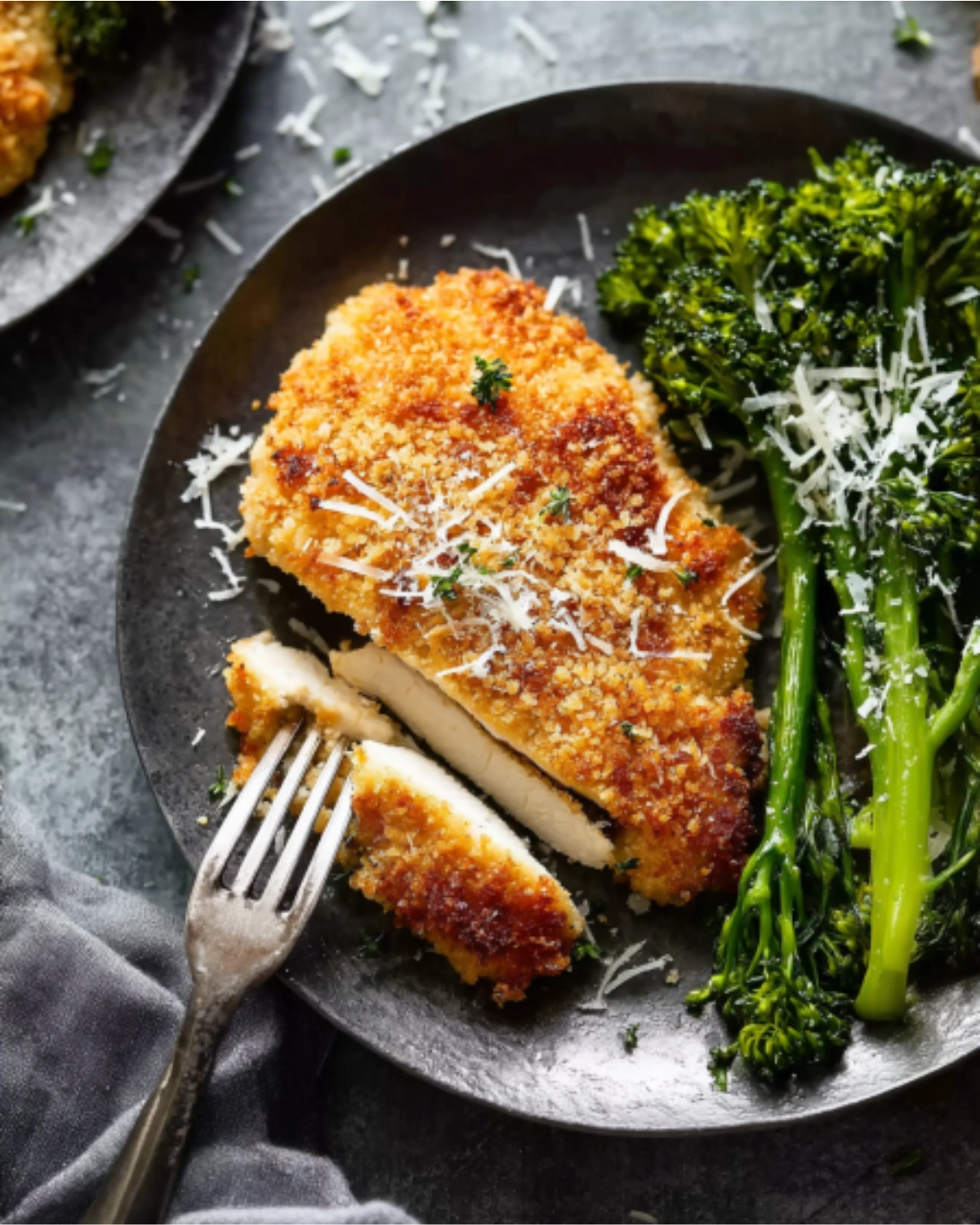 Parmesan Crusted Chicken Recipe served with broccolini and grated cheese
