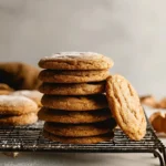 Stack of Maple Pumpkin Cookies on a cooling rack, lightly dusted with sugar.