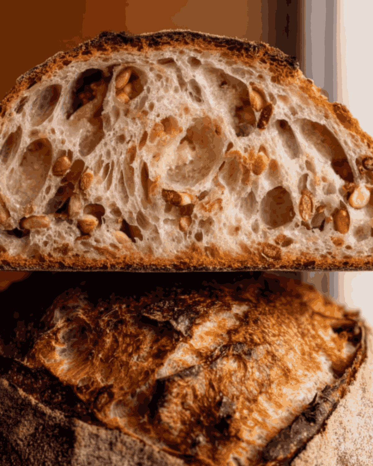Close-up of sliced sourdough pumpkin apple bread showing airy crumb and toasted pumpkin seeds