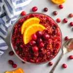 Fresh Cranberry Orange Relish made with whole cranberries and orange slices in a clear glass bowl