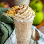 Apple Pie Milkshake served in a vintage glass, topped with whipped cream, cinnamon, and a slice of apple pie