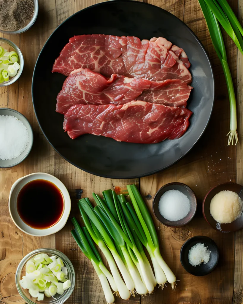 Raw flank steak and fresh scallions arranged with soy sauce and seasonings for Beef Negimaki preparation.
