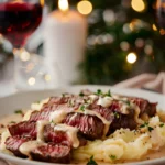 Pan seared garlic butter steak slices served over creamy mashed potatoes with rich garlic sauce and fresh herbs.