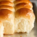 Close-up of soft and fluffy Old Fashioned Yeast Rolls with a golden crust on a baking sheet