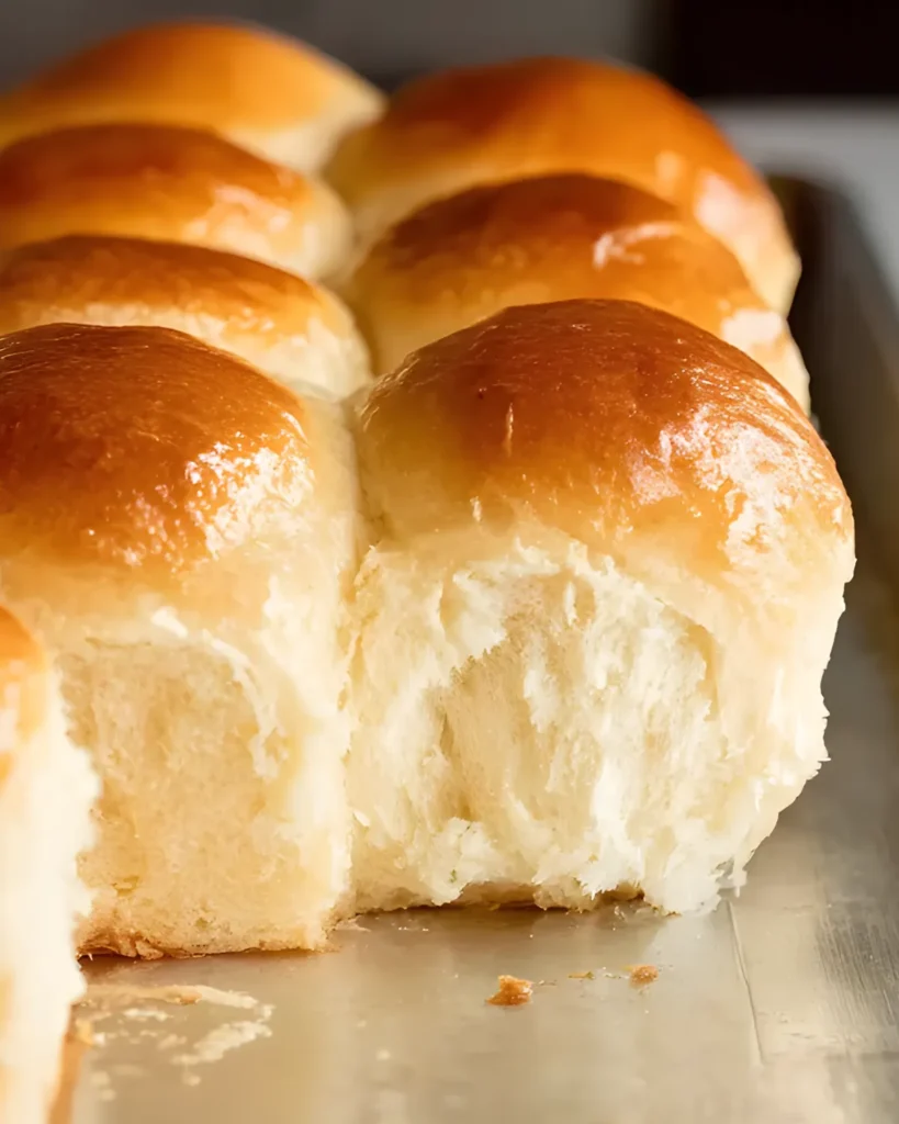 Close-up of soft and fluffy Old Fashioned Yeast Rolls with a golden crust on a baking sheet
