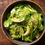Yamitsuki Cabbage Salad in a bowl topped with black and white sesame seeds and light dressing