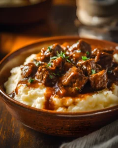 5-ingredient beef tips and gravy served over creamy mashed potatoes with tender beef chunks